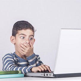 Child surprised while looking at a laptop