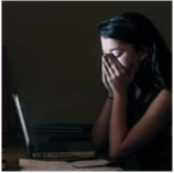 Upset young person at a laptop